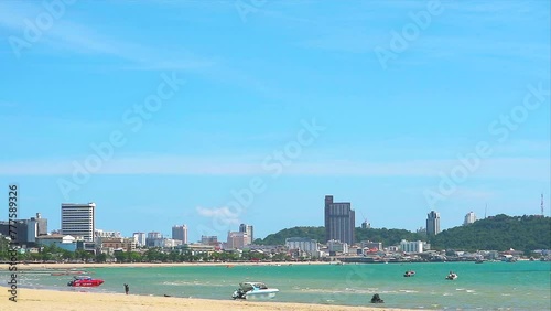Gulf of the pattaya city and boat parking near beach with blue sky white cloud