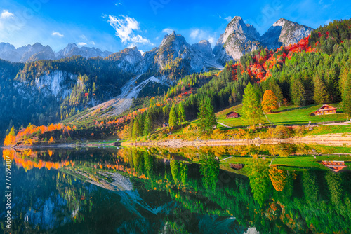autumn scenery with Dachstein mountain summit reflecting in crystal clear Gosausee mountain lake © FaiV007