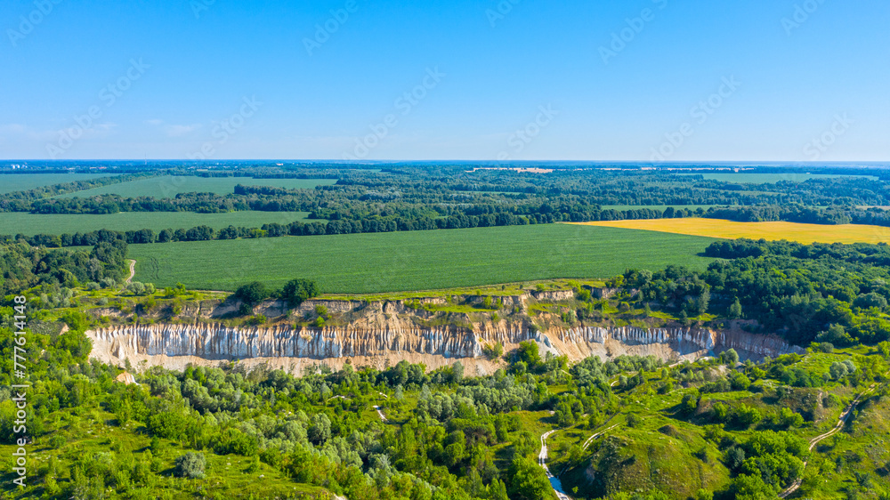 Aerial drone view - Beautiful summer landscape old chalk quarry. Bird view over nature landscape with old chalk quarry. Beautiful hilly.
