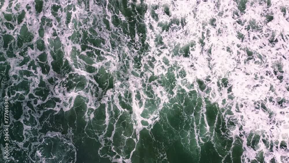 waves crashing by the seashore on stormy day aerial drone view of wild beach in the coastline of Spain. waves crashing by the seashore on stormy day aerial drone view of wild beach in the coastline of Spain.