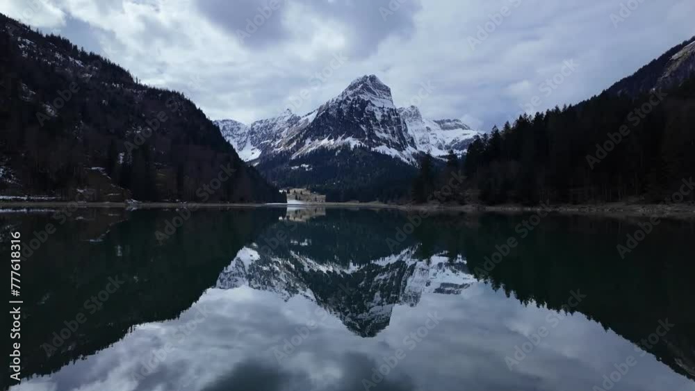 Crystal clear Lake Obersee in which a high snow-capped mountain is reflected. Amazing natural scenery of mountain apl landscape in switzerland Crystal clear Lake Obersee in which a high snow-capped mountain is reflected. Amazing natural scenery of mountain apl landscape in switzerland