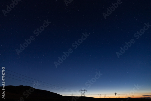 Night sky with stars at sunset with mountain silhouette