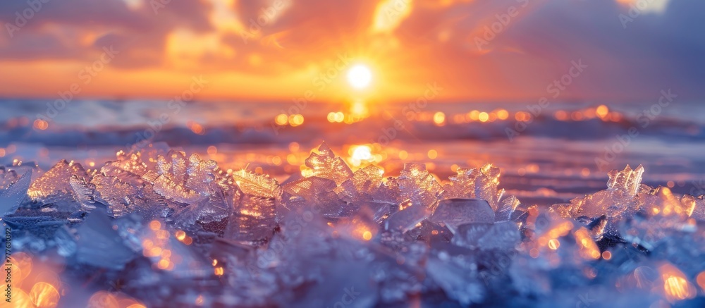 The sun dips below the horizon, casting a warm glow over the icy ocean waters. Ice crystals glisten on the shore as the day comes to an end. The sun dips below the horizon, casting a warm glow over the icy ocean waters. Ice crystals glisten on the shore as the day comes to an end.