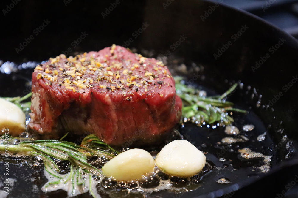 Ταπετσαρία Seasoned raw filet mignon searing in cast iron skillet