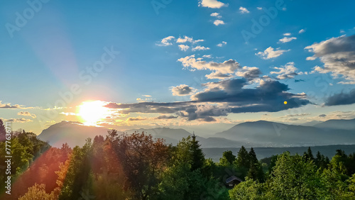 Scenic sunset view of mount Dobratsch and Lake Faak seen from Altfinkenstein at Baumgartnerhoehe, Carinthia, Austria. Tranquility on hiking trail. Overlooking Villach area surrounded by Austrian Alps