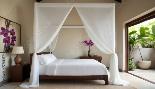 An inviting bedroom with a minimalist canopy bed draped in sheer white fabric, surrounded by smooth cream stone walls adorned with handcrafted Balinese-inspired artwork and a vibrant orchid arrangemen