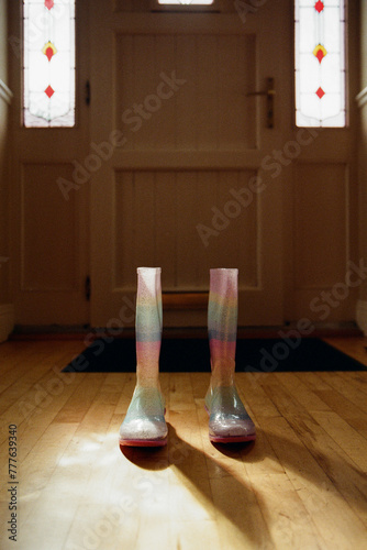 Girl's rainbow rain shoes by the main entrance