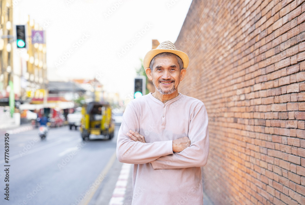 senior man tourist standing outdoors in the city, older adult travel in southeast asia,destination in Chiang Mai,Thailand,concept of elderly pensioner lifestyle,travel