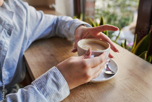 Woman hands holding cup of coffee photo