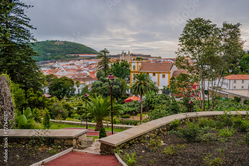Trees in the Duque da Terceira garden with view of the architecture of Angra do Heroísmo and Monte Brasil in the background, Terceira - Azores PORTUGAL photo