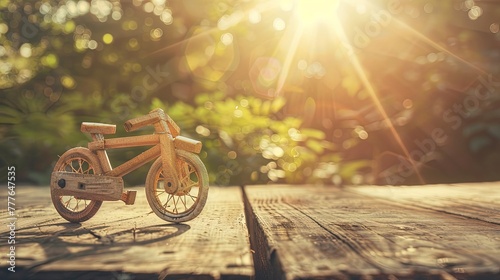Old miniature wooden bicycle on wooden table. World bicycle day. Vintage beauty on display.