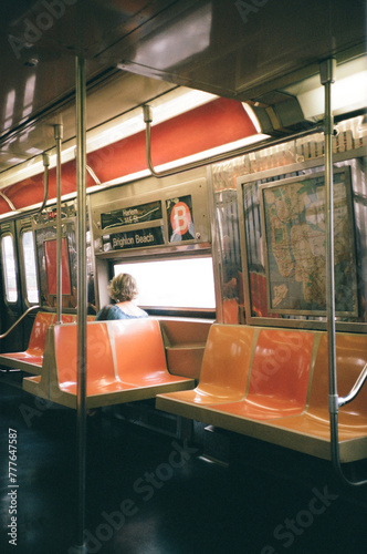 Inside of B train. New York City. Woman sits in an empty subway car.  photo