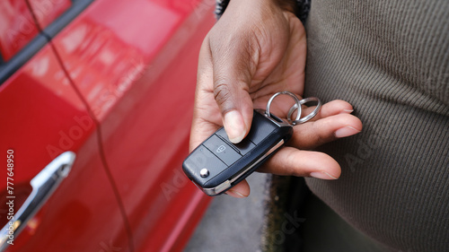 Crop of hand opening car with remote key photo