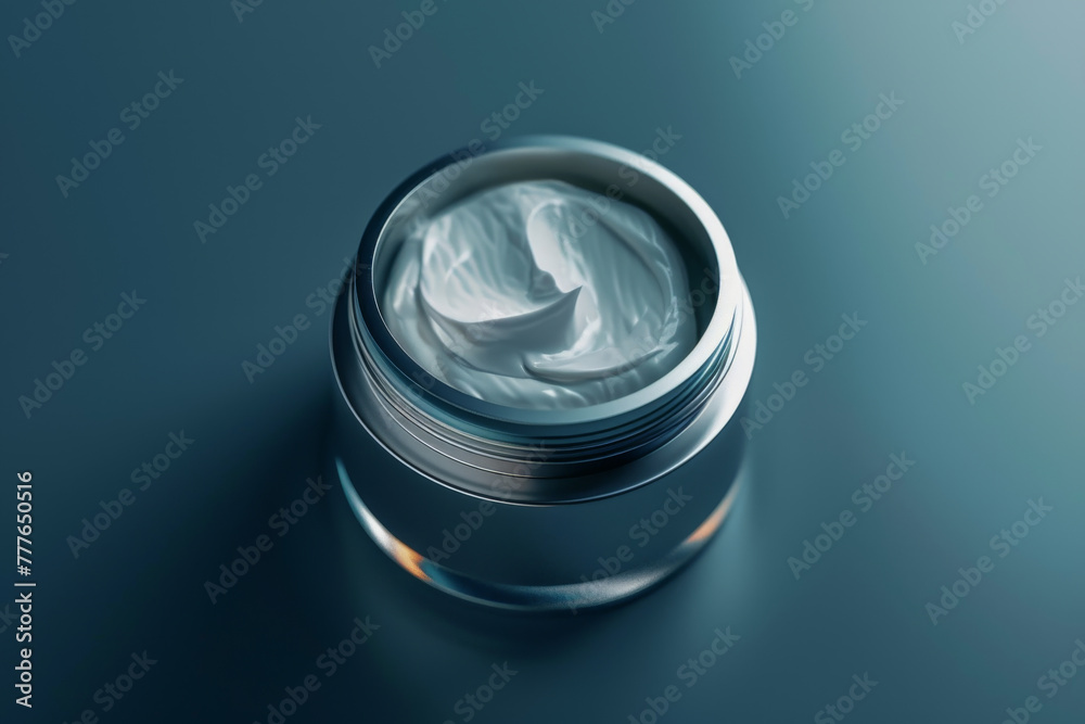 A small jar of cream is sitting on a table A small jar of cream is sitting on a table