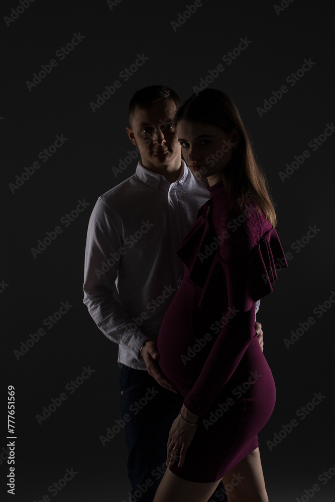 portrait of a pregnant couple on a black background, pregnant couple close up portrait of a pregnant couple on a black background, pregnant couple close up