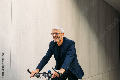 Senior man riding bike photo