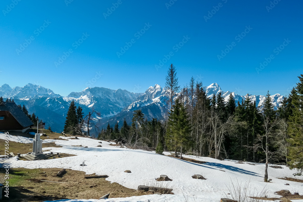 Scenic view of snowcapped mountain peaks of Julian Alps seen from Dreilaendereck, Karawanks, Carinthia, Austria. Hiking in remote alpine landscape in early springtime in Austrian Alps. Wanderlust