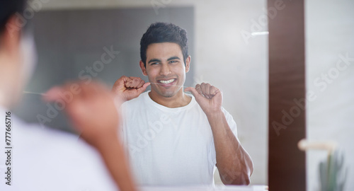 Happy  mirror and man with floss in bathroom for dental hygiene  gum disease and oral care. Health  mouth and person in reflection after brushing teeth for wellness  cleaning and fresh breath in home