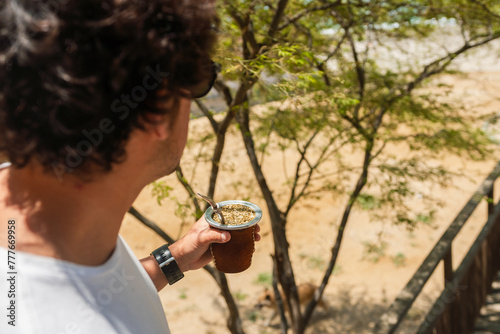 Man holding a yerba mate tea cup photo