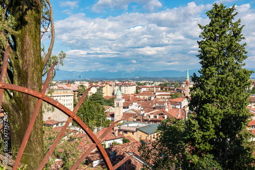 Aerial panoramic view of historic city of Udine, Friuli Venezia Giulia, Italy, Europe. Viewing platform form castle of Udine. Cloudy overcast day. Distant view of mountains of Alps, border to Austria photo