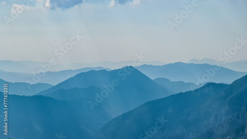 Scenic view of silhouettes of mountains seen from Allakogel in Hochschwab region, Styria, Austria. Wanderlust in wilderness of Austrian Alps, Europe. Panorama of Fischbacher Alpen and Muerztal valley photo