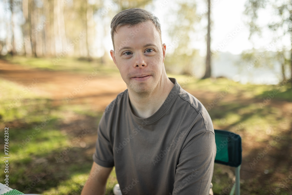 portrait of man with down syndrome in nature portrait of man with down syndrome in nature