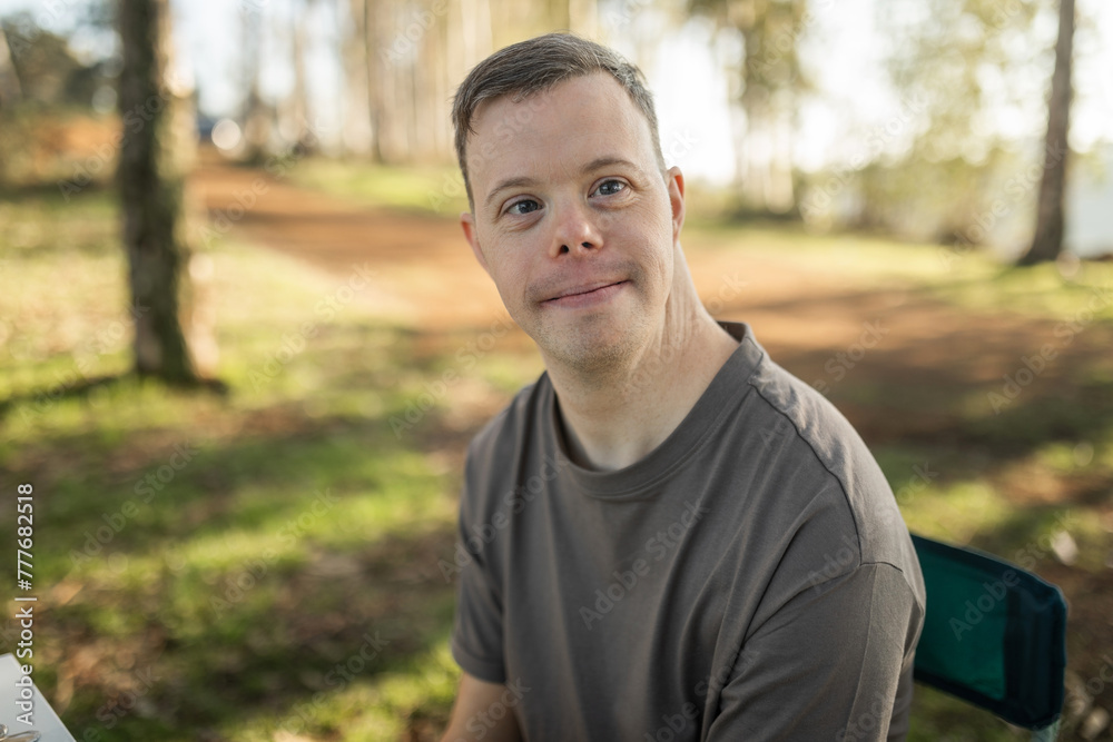 portrait of man with down syndrome in nature portrait of man with down syndrome in nature