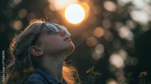 Child looking at solar eclipse through protective eyewear, marveling at the sky's spectacle.