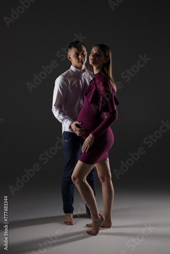 portrait of a pregnant couple, pregnancy couple posing in a studio, studio pregnancy shoot