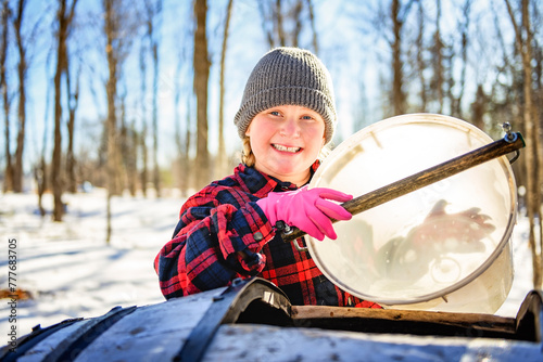 sugar shack, child having fun at mepla shack forest collect maple water photo