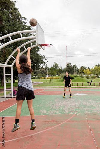 Two female athletes work on honing their throwing abilities