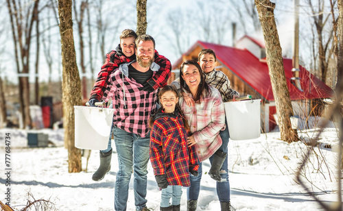 Foto family close to a maple shack having fun together