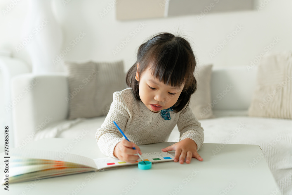 Cute asian preschool little girl painting picture at home Cute asian preschool little girl painting picture at home