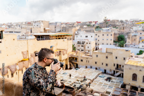 A man taking photos in a tannery in Morocco photo
