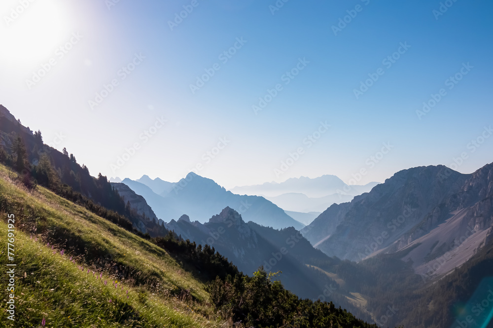 Scenic view of mountain peak Grintovec in majestic Kamnik-Savinja Alps, Slovenia, Europe. Magnificent Hiking trail on Loibl Pass in untamed Karawanks, Austrian border. Magical mountains Slovenian Alps Scenic view of mountain peak Grintovec in majestic Kamnik-Savinja Alps, Slovenia, Europe. Magnificent Hiking trail on Loibl Pass in untamed Karawanks, Austrian border. Magical mountains Slovenian Alps