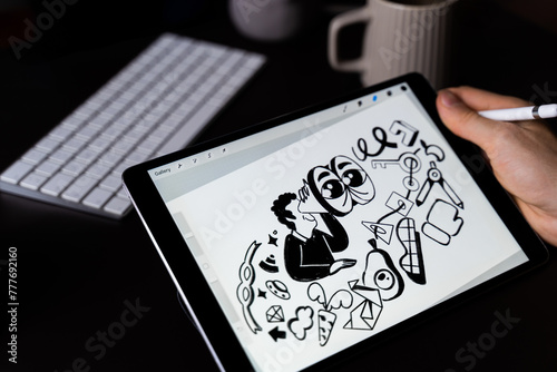 Designer drawing illustration on digital tablet in home workplace
 photo