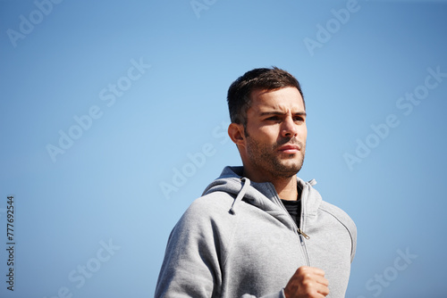 Man, jog and exercise in outdoor for fitness, workout and body health for physical training. Male runner or athlete and run for cardio, active strength or recreation in summer outside for fresh air