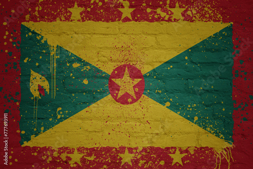 painted big national flag of grenada on a massive old brick wall