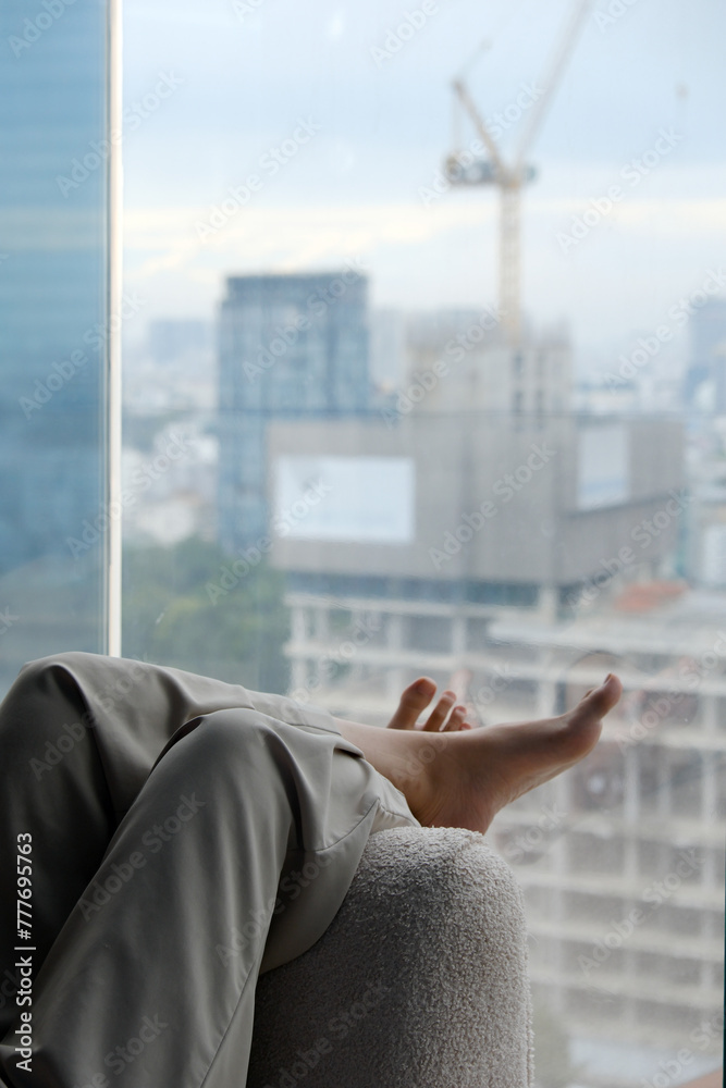 Female Legs In Wool Pants Relaxing On Sofa Female Legs In Wool Pants Relaxing On Sofa