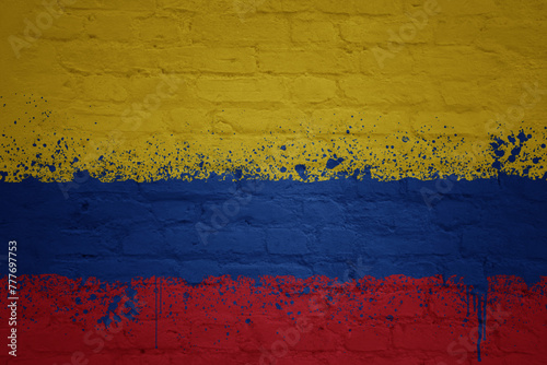 painted big national flag of colombia on a massive old brick wall