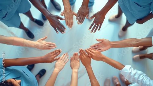 A circle of healing hands: An aerial view capturing a multiethnic medical team's hands together, forming a circle of unity and shared purpose photo