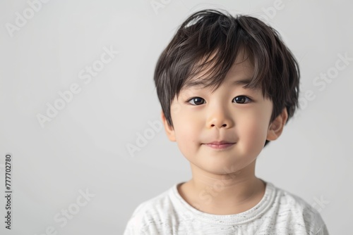 Cute Asian Child in White Tee with a Gentle Smile. Generative AI.