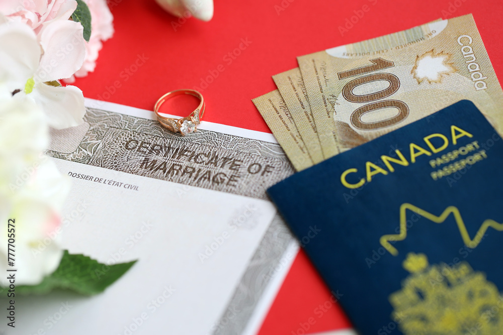 Fototapeta premium Canadian Certificate of marriage document and wedding ring with canadian dollars and passport close up
