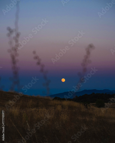 Moon rising above horizon in Redwood City, California photo
