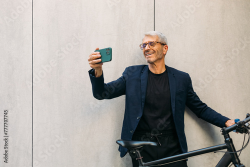 Senior man making selfie outside photo