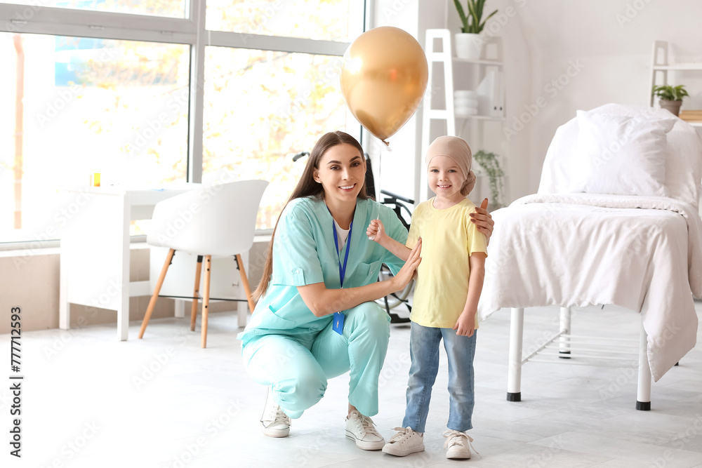Little girl after chemotherapy with golden balloon and nurse in clinic - obrazy, fototapety, plakaty 
