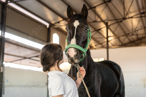 funny moment between a girl and  horse  in equestrian therapy  photo