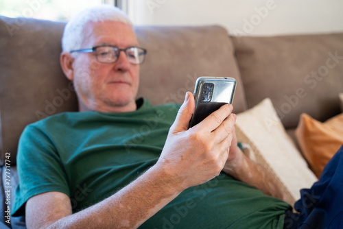 retired man use phone at home