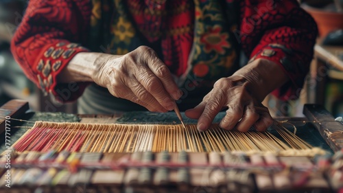 Close-up of hands weaving on traditional loom with skilled craftsmanship