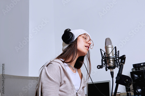 A songwriter sings into the microphone with emotion. photo